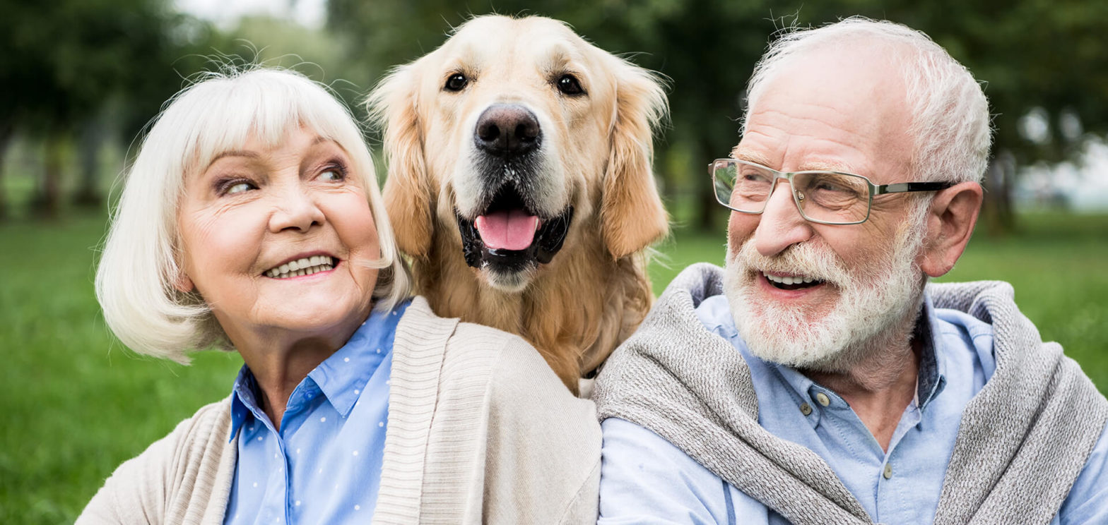 Senior couple smiling with dog