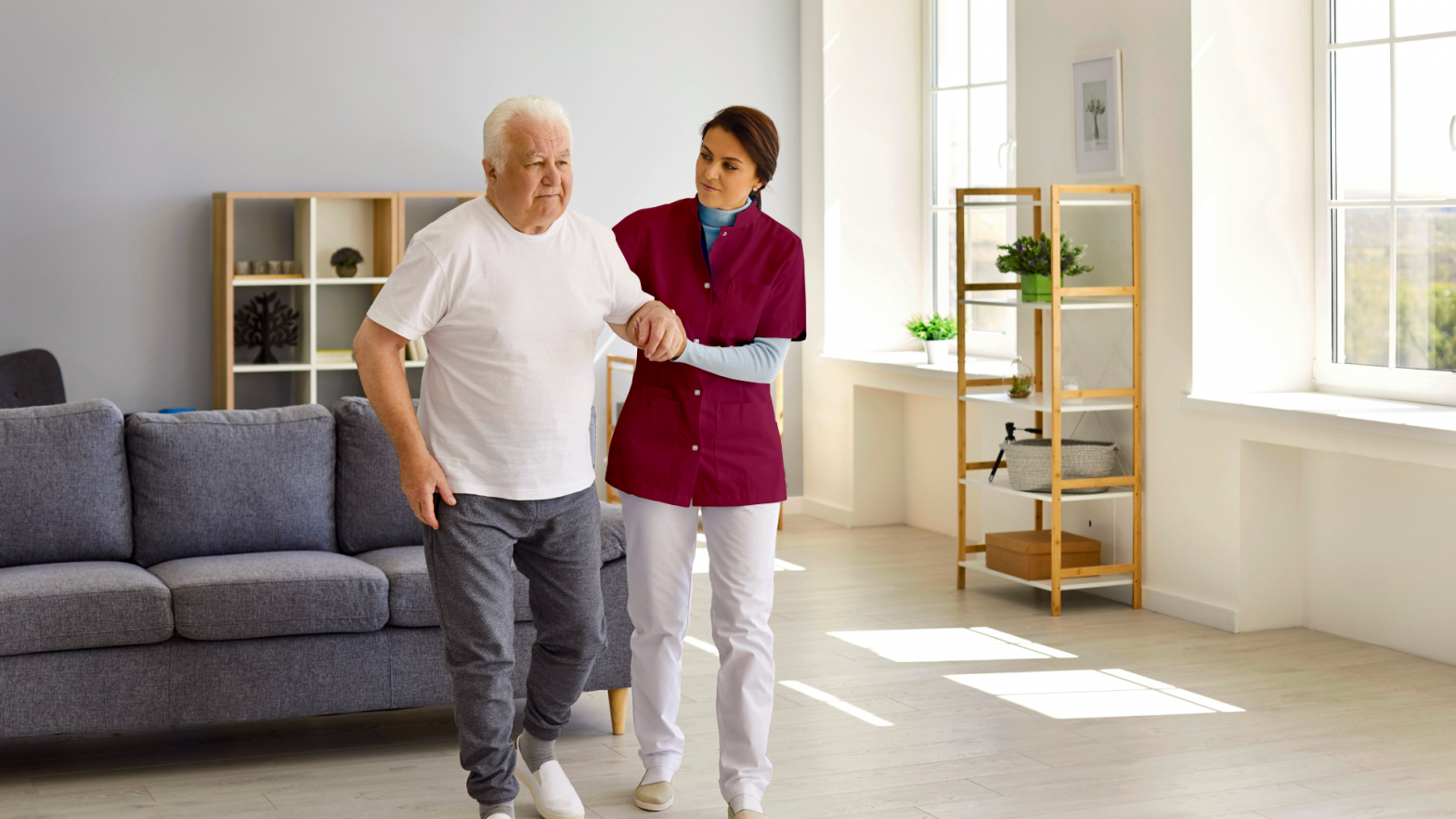 In-home caregiver providing support to senior man